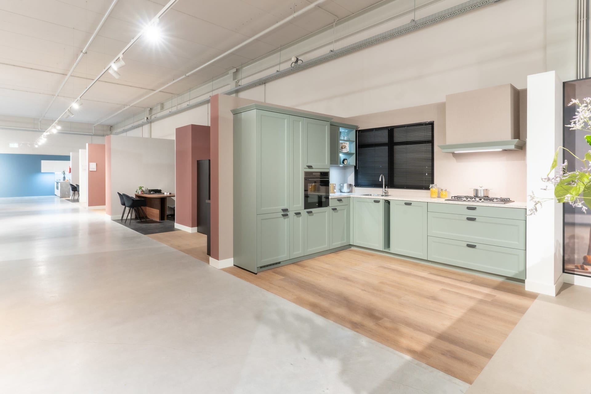 Zachtgroene keukenopstelling met houten accenten in de Kitchen4All-winkel