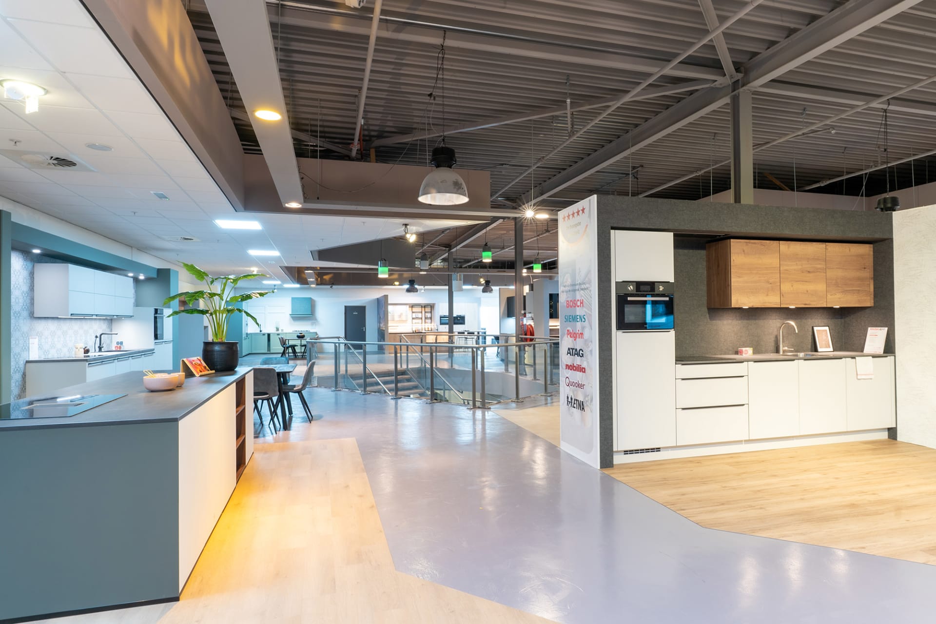Lichte keukenopstelling met eiland en hangplanten in de Kitchen4All-winkel