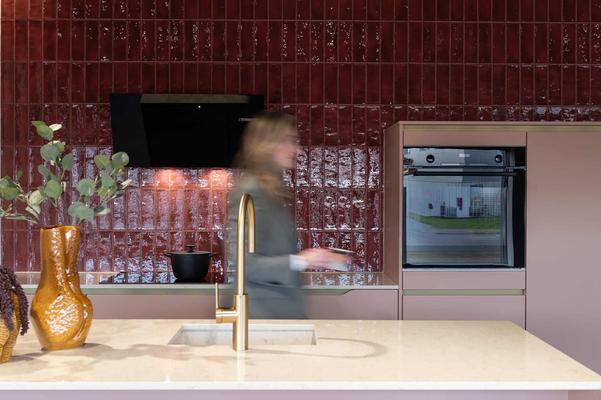 Moderne Kitchen4All eilandkeuken met matte beige en taupe fronten, composiet werkblad en greeploze afwerking.