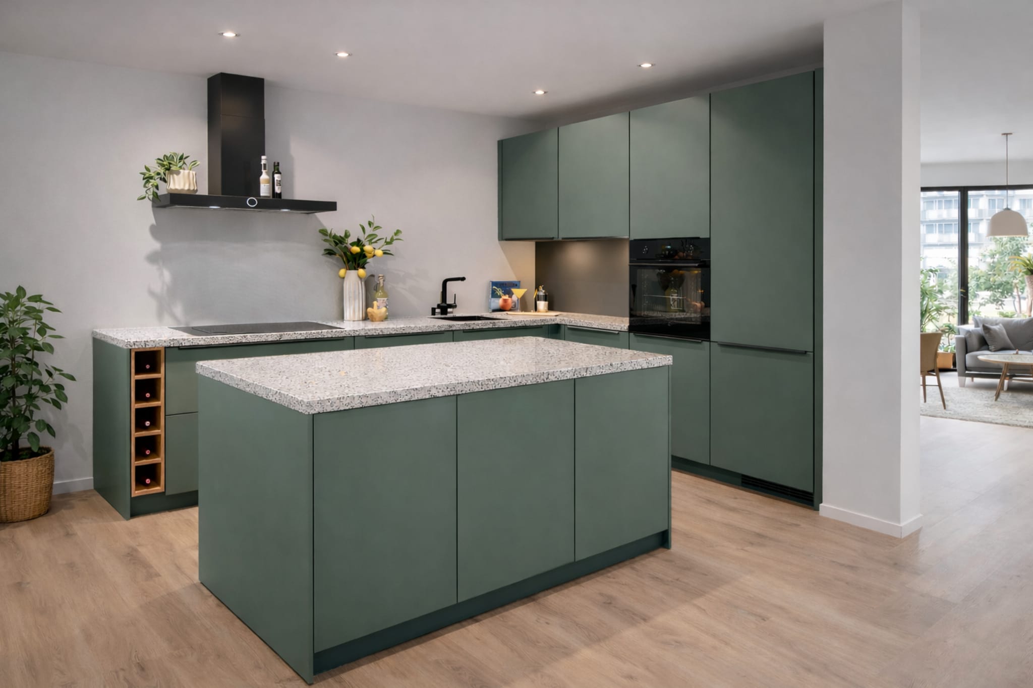 Moderne Kitchen4All L-keuken met kookeiland, matgroene fronten en een grijs composiet werkblad.