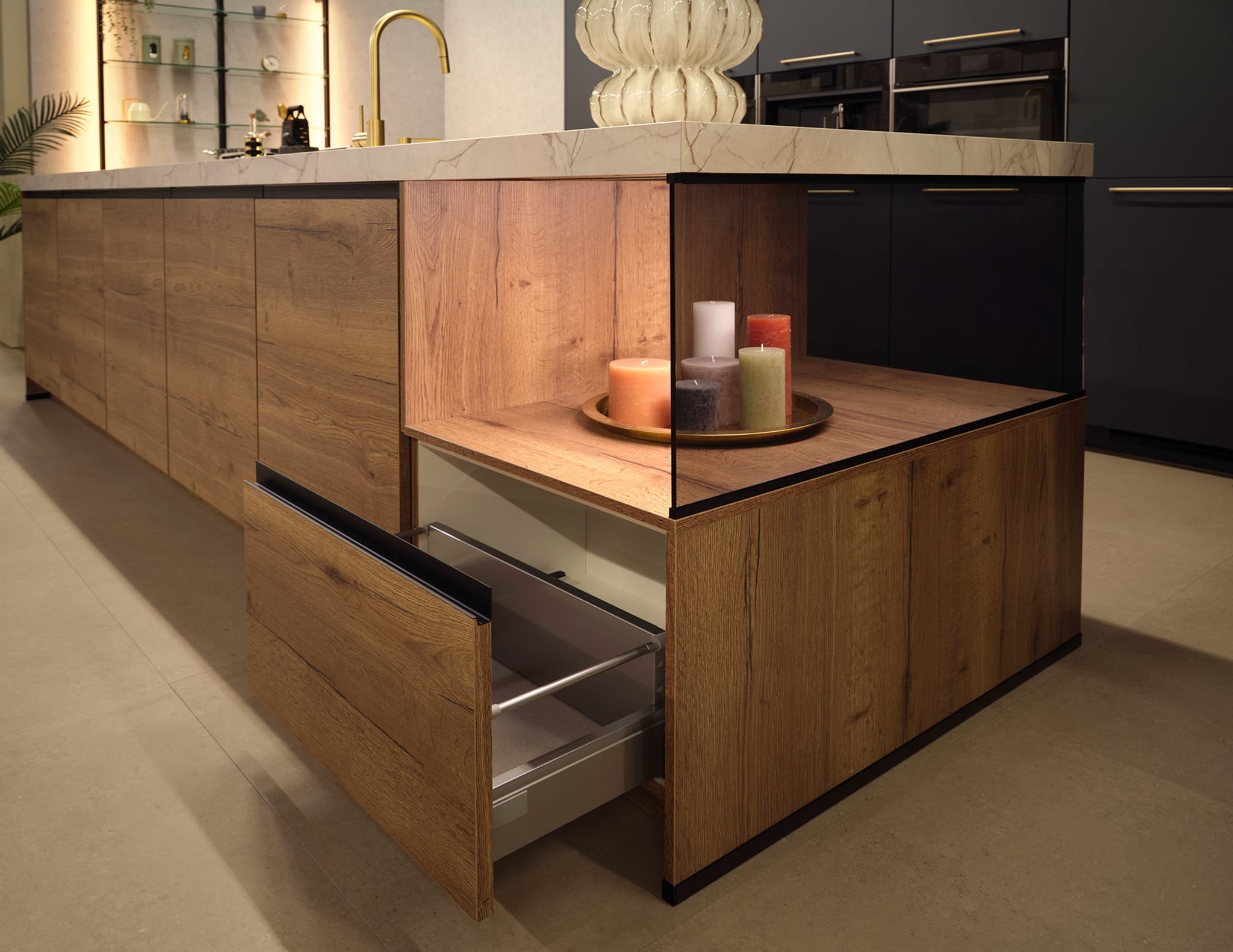 Modern kookeiland met greeploze houtlook fronten en een marmerlook werkblad, perfect voor een open keuken.