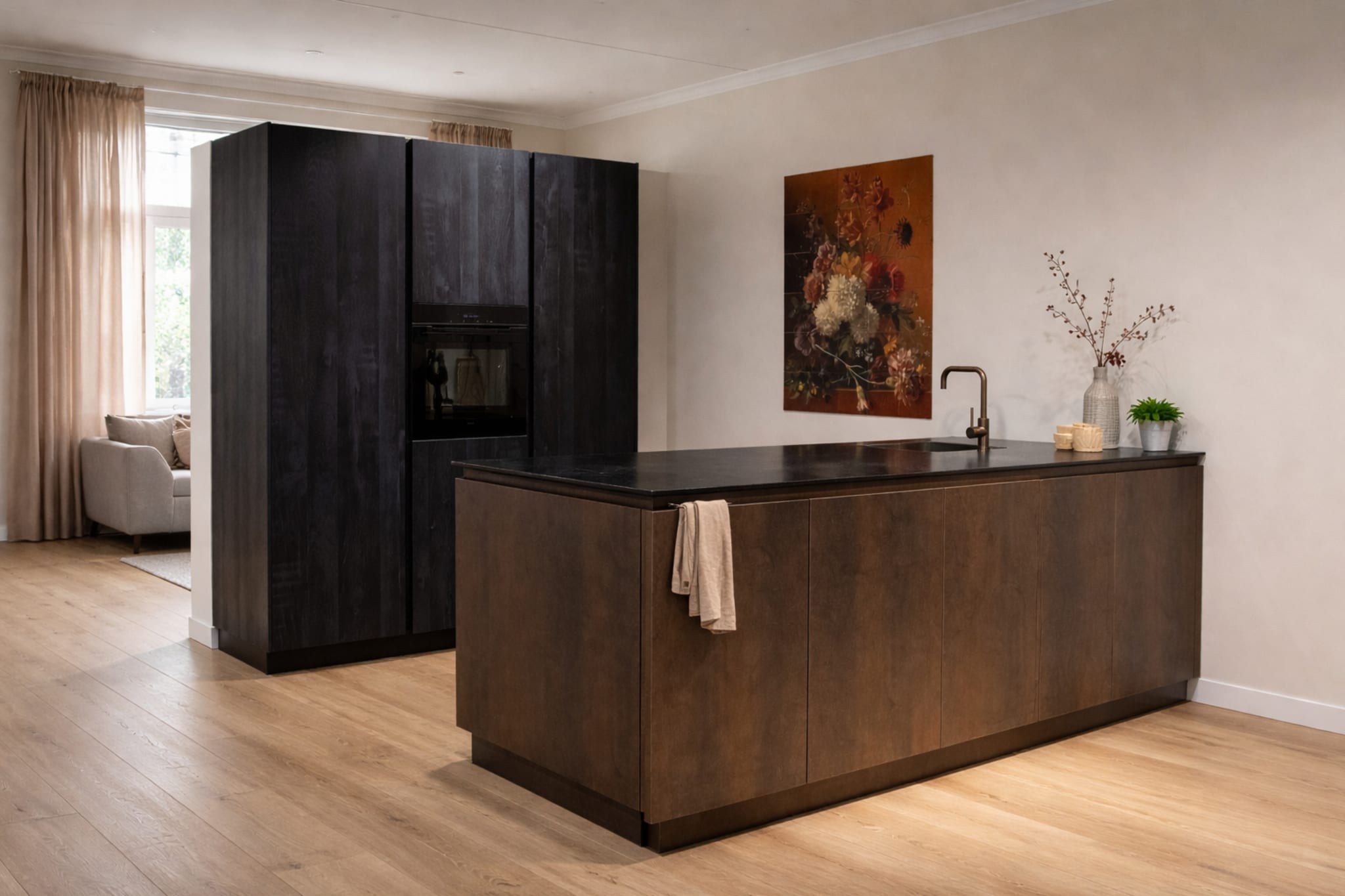 Een moderne Kitchen4All eilandkeuken met donkere houten fronten en een zwart granieten werkblad.