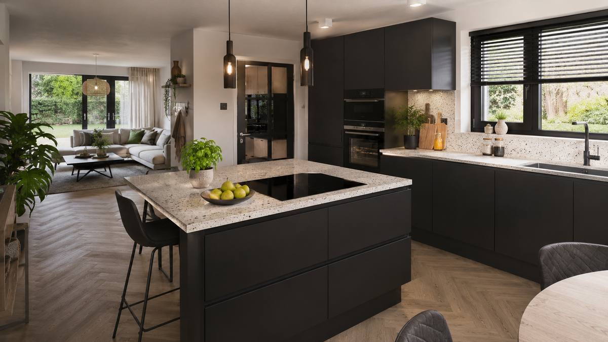 Zwarte keuken met terrazzo kookeiland en eethoek